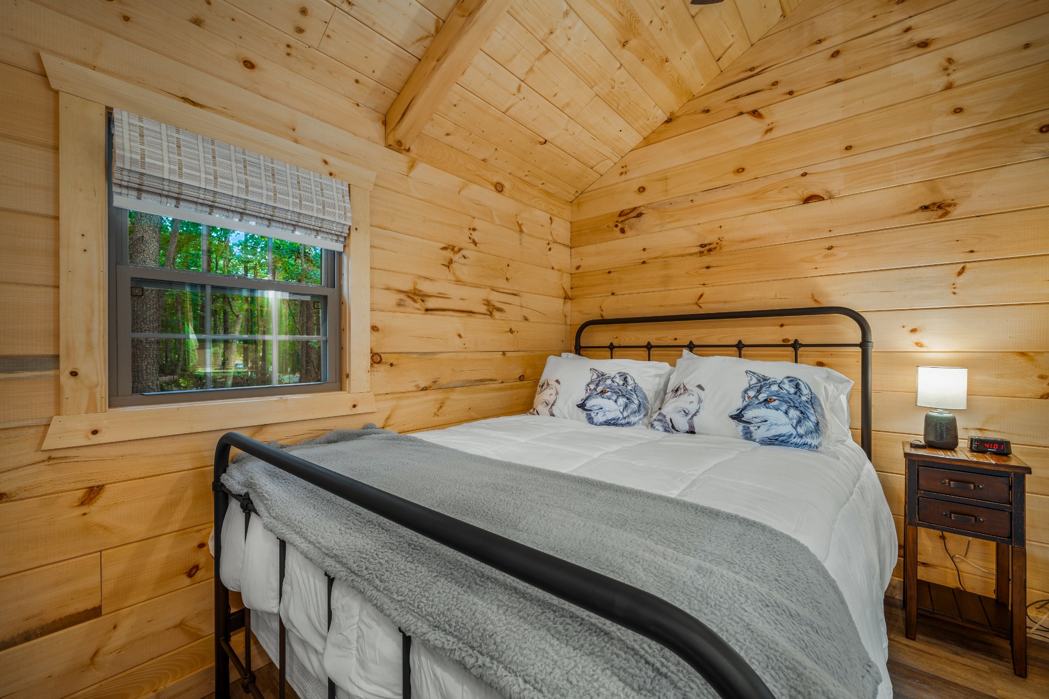Cozy cabin bedroom with wood-paneled walls